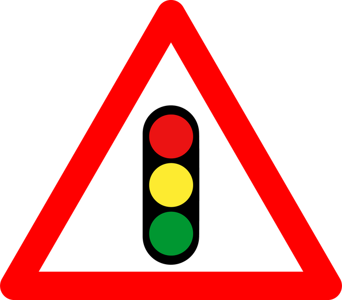 Traffic light regulation sign. Warning sign traffic is regulated by traffic light. Red triangle sign with traffic light silhouette inside. Caution traffic light. Road sign.
